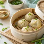 Steaming vegan soup dumplings in a bamboo basket